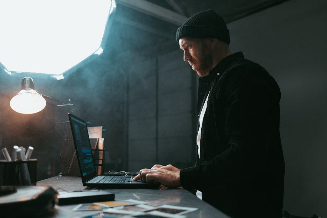 A person works with calm focus at a clean, minimal desk with a laptop, bathed in natural light, symbolizing clarity in AI marketing and SEO.